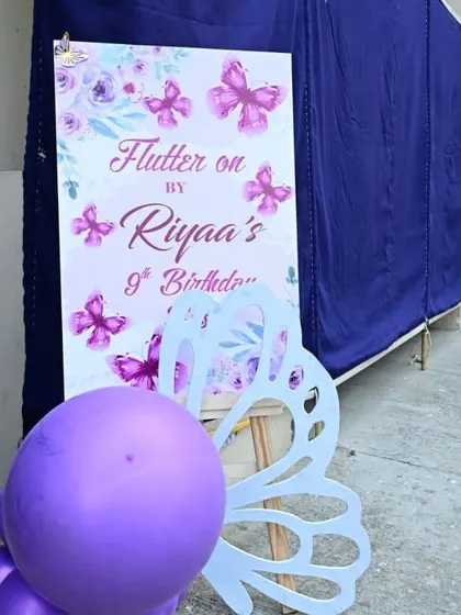 The personalized welcome sign for "Riyaa's 9th Birthday," featuring a purple butterfly motif.