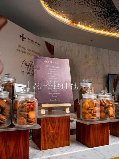 The cookie and biscuit bar, featuring large glass jars filled with treats. This setup is both visually appealing and practical for guests to help themselves during the corporate event.