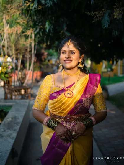A beautiful yellow and purple Kanchivaram saree paired with a fully embroidered yellow blouse. The color combination is traditional yet vibrant.