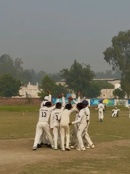 The team celebrates a run-out. Every player is involved.