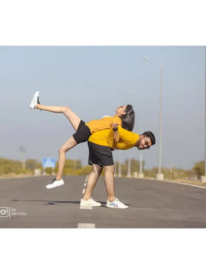 A playful and acrobatic pose that shows the couple's fun-loving spirit. I always encourage couples to be themselves and have fun during the shoot.