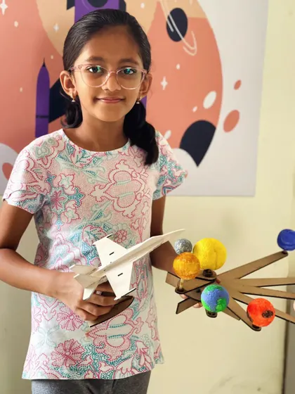 This student showcases two amazing projects: a model of the solar system and a sleek jet plane she built.