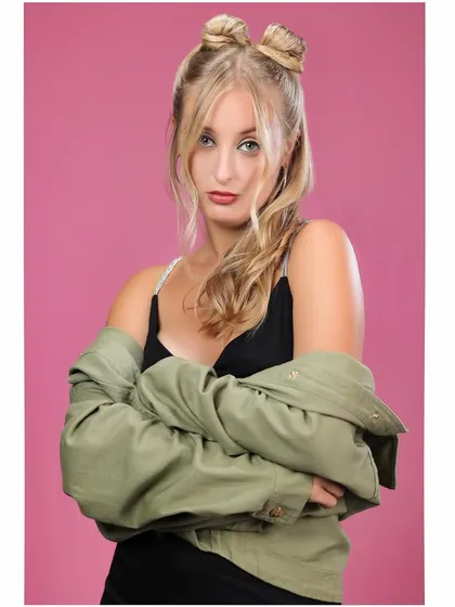 A more direct and assertive pose from the same series. The model's crossed arms and direct gaze convey a strong sense of attitude.