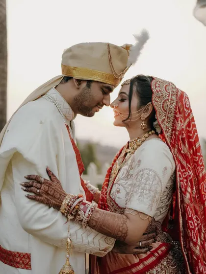 A classic, romantic portrait of the bride and groom. Their foreheads touching, eyes closed, they are lost in their own world on their wedding day.