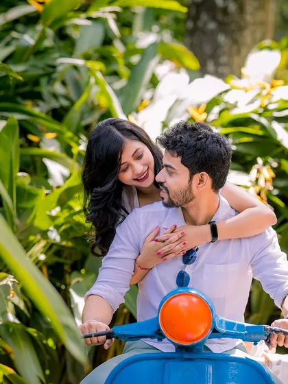 A sweet, candid moment on a scooter. The bride's affectionate gesture and the groom's happy smile are what make this pre-wedding photo so special.