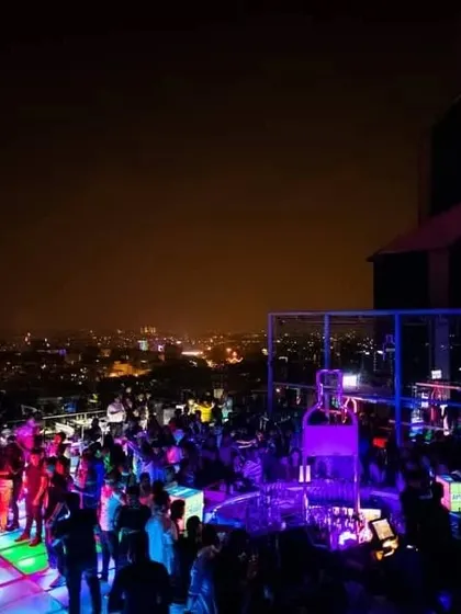 The vibrant colors of the dance floor and the city lights make for an unforgettable party atmosphere at Skyye.
