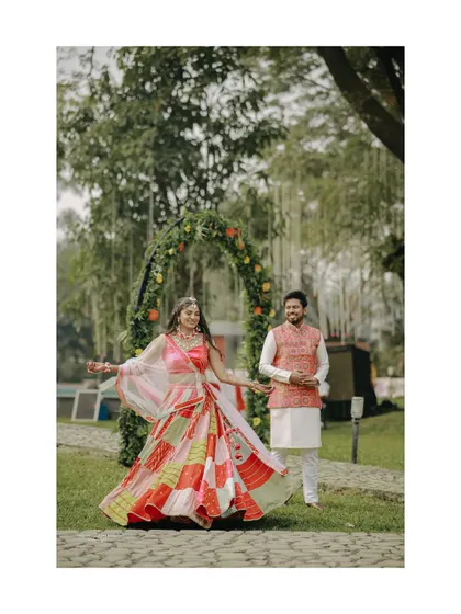 The bride twirls in her colorful patchwork lehenga, a beautiful and joyful shot from her Haldi day celebrations.