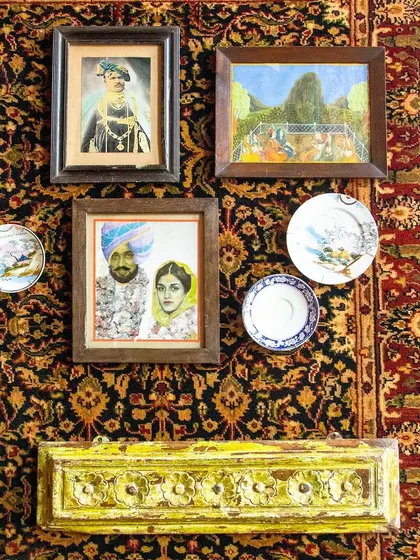Enter a world where every corner is a canvas. This wall is adorned with intricate motifs, vintage portraits, and hand-painted plates that tell tales of distant lands.