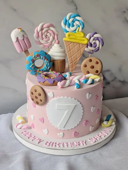 Candyland dreams come true with this colorful cake. It's overloaded with edible lollipops, ice cream, donuts, and cookies.