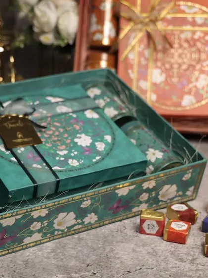 A closer look at our floral and bird-themed Diwali boxes. The vibrant colors and detailed artwork make them a beautiful gift in themselves.