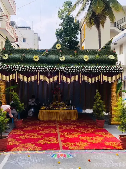 A traditional 'chapra' set up for an outdoor ceremony, complete with a decorated table and seating area underneath.
