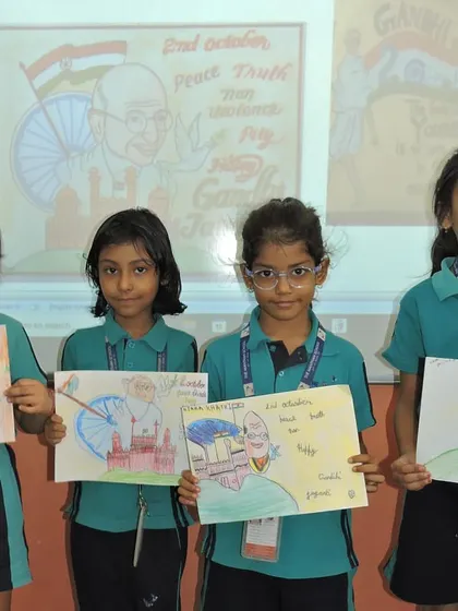 Students proudly display their finished posters honoring Mahatma Gandhi and his teachings.
