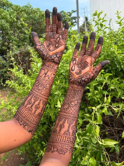 The back of the hands for the bridal mehendi, showing how the intricate design continues all the way around the arm for a complete and stunning look.