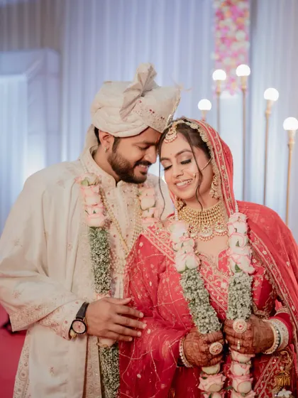 An intimate and happy close-up of the bride and groom at their reception, their faces close together.