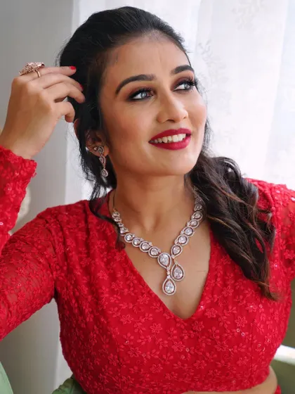 A beautiful, happy shot of my muse Gagana in a vibrant red outfit. The makeup is soft and glowing, with a classic red lip and defined eyes to match.