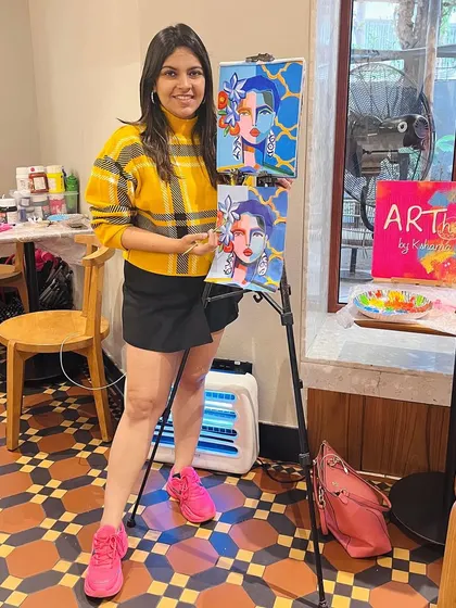 Me standing by my demonstration canvas at a cafe workshop. I paint along with the participants to guide them through every step.