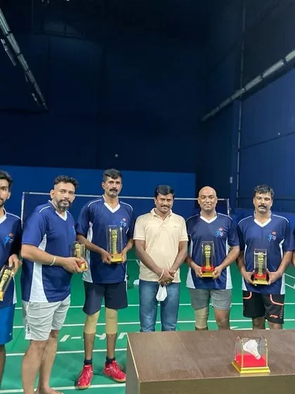 A group of winners from our adult league, each holding their individual trophies.