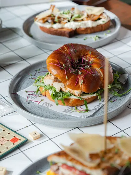 A beautiful overhead shot of our bagel sandwich and an open-faced toast. Our plates are designed to be as pleasing to the eye as they are to the palate.