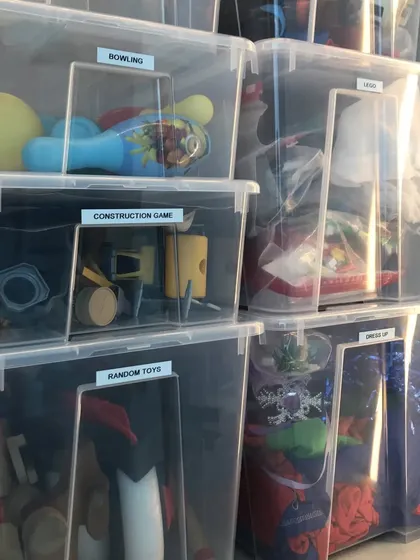 Labeled, clear bins are a parent's best friend. We use them to organize kids' toys by category, such as "Construction Games" and "Dress Up," which makes finding specific toys and cleaning up much easier.