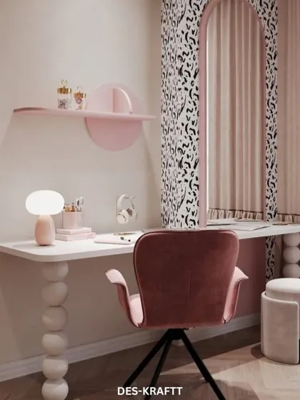 Another angle of the creative workspace, highlighting the pink velvet chair and the simple, floating shelf that adds a pop of color.
