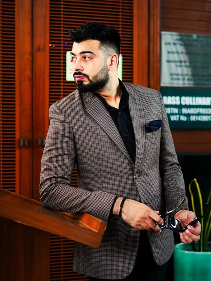A classic brown plaid blazer is a must-have for any wardrobe. Paired with a black shirt, it creates a sophisticated and slightly edgy look that works for both the office and after hours.