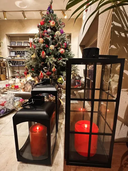 Our classic black lanterns in two different shapes, filled with red pillar candles, create a bold and timeless Christmas statement.