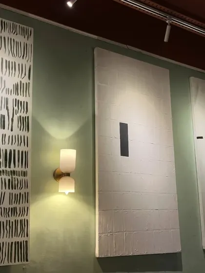 The three minimalist cafe paintings seen together. Their large scale and simple, bold graphics make a huge impact in the space.