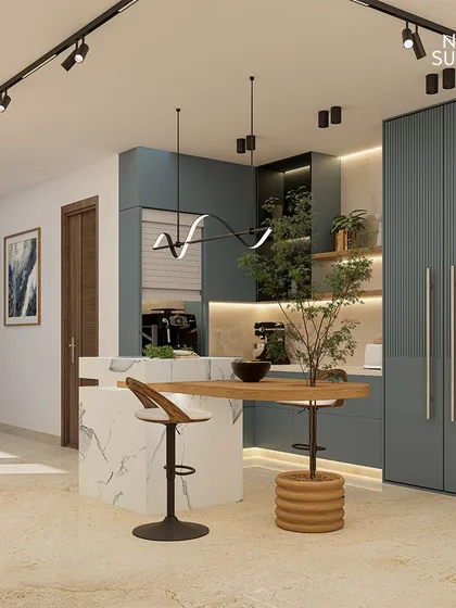 This angle showcases the kitchen's central island, which features a unique wooden tabletop extension for casual dining. The design incorporates greenery and modern lighting to create a space that is the true heart of the home.