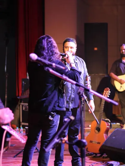 A shot showing the on-stage collaboration between vocalists Ash King and Nikhil Paul George.