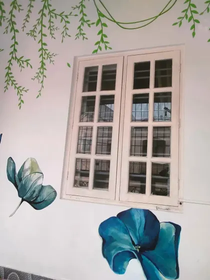 Another angle of the floral mural, showing how the hand-painted design elegantly frames the window.