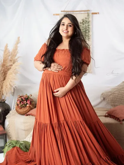 A beautiful solo portrait of the mom-to-be in our boho setup. The warm, earthy tones and her happy expression make this a favorite.