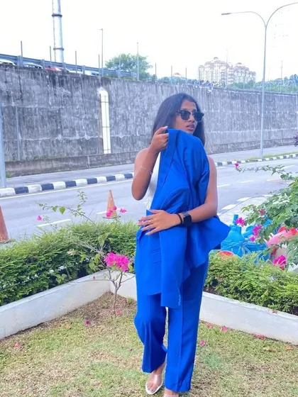 A casual shot of the client with her custom blue blazer, showing its versatility.