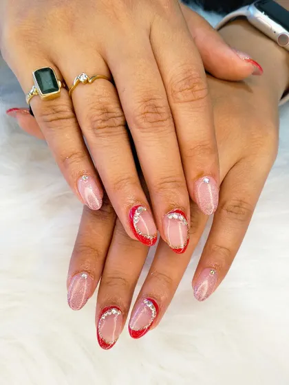 A full view of the stunning red and gold bridal nails, showing how the design comes together for a look that is both festive and elegant.