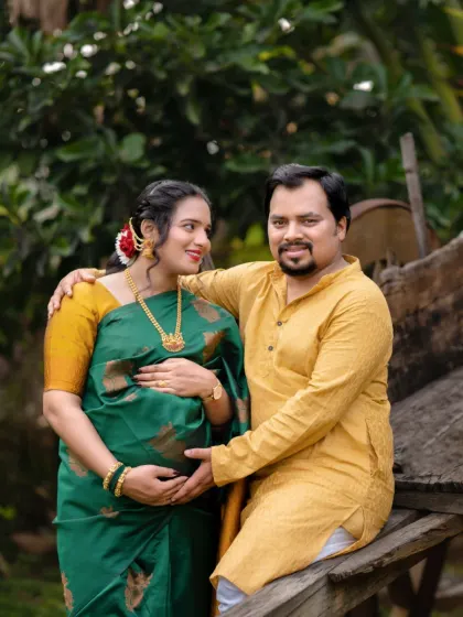 Two hearts, one soul, and a tiny new heartbeat. This couple's portrait, taken outdoors in traditional wear, is full of warmth and happiness.