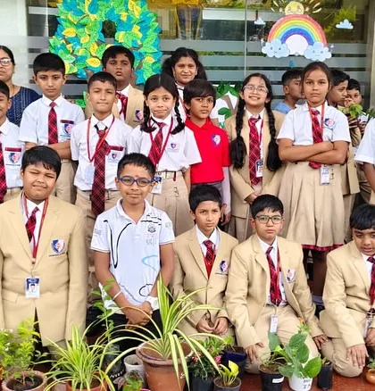 Students from different grades come together to plant saplings, fostering a school-wide culture of environmental responsibility.