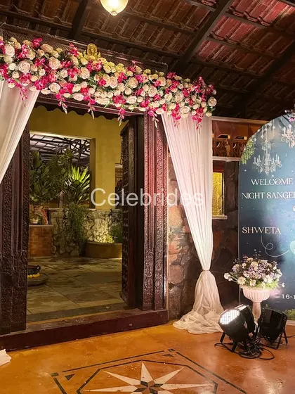 A "Starry Night" themed entrance for a Sangeet ceremony. The custom welcome board and floral arch set a magical mood.