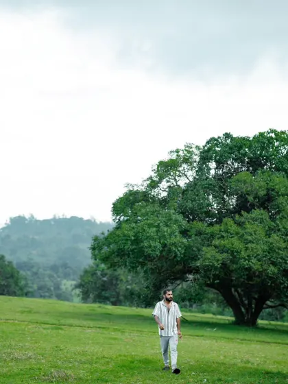 Walking through a vast green meadow. This image conveys a sense of freedom and the simple joy of being in nature.