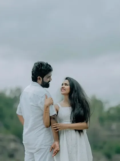 A romantic portrait of a couple against a natural, hilly backdrop. The simplicity of the scene allows their connection to be the main focus.