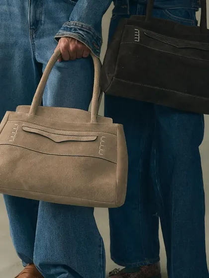 An exploration of silhouette and material with our Penny Carryall bags in sumptuous suede. I designed these to be a modern, unisex classic, combining a structured form with the soft, yielding texture of premium suede for a piece of everyday luxury.