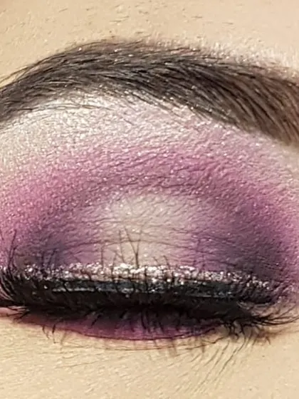 This is a purple halo eye look I created. The technique involves placing a darker shadow on the inner and outer corners of the eyelid and a light, shimmery shade in the center to make the eyes look bigger and brighter.
