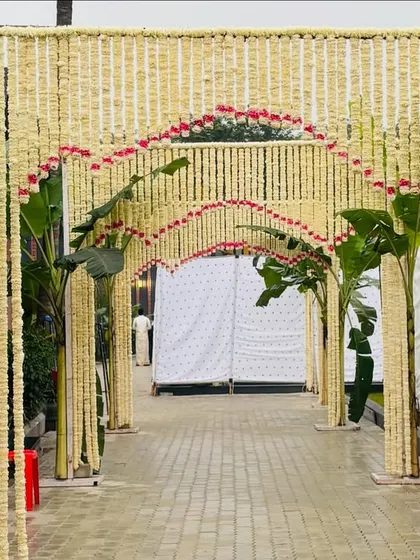 A closer view of the traditional floral walkway, showing the intricate arches made of jasmine and the fresh banana plant pillars that define the path.