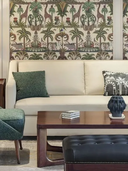 A living room detail from the Max128 project, highlighting the unique wallpaper and curated furniture.
