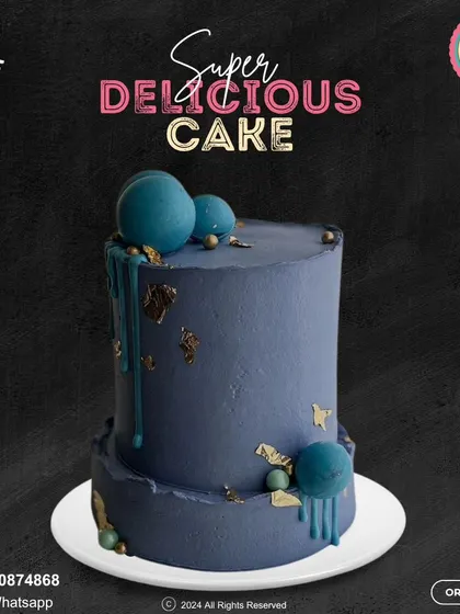 A sophisticated two-tier cake in a deep, moody blue. This design is adorned with artistic drips and gold leaf accents, creating a modern and elegant look for an upscale celebration.