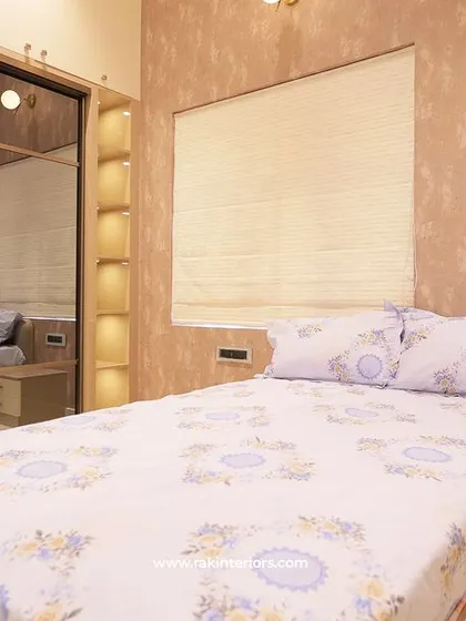 The bedroom with the mirrored wardrobe, showing how it reflects light and makes the room feel more spacious.
