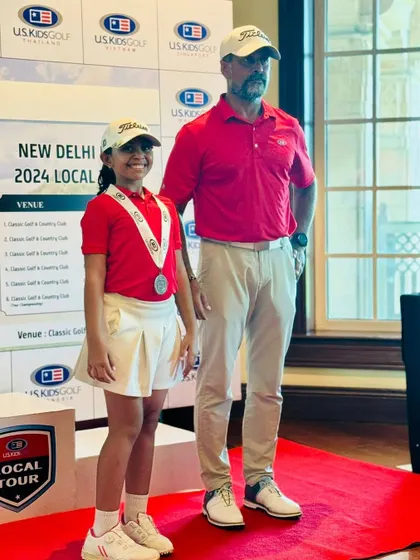 Aahana Shrivastava stands with our Head Pro on the podium after securing 3rd place in the US Kids Golf Tournament, showcasing the bright future of our junior golfers.