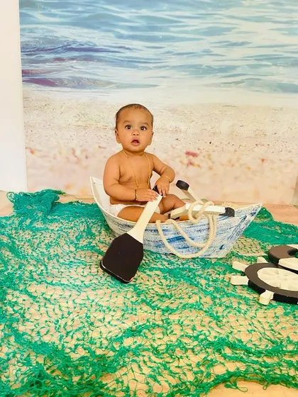 Explore our full nautical and beach-themed collection. These images showcase the variety of poses and angles possible with our boat prop, sand-colored flooring, and ocean backdrop.