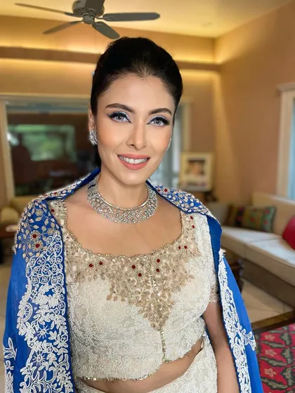 A striking look for this beauty. I paired a sharp blue winged liner with luminous skin and a natural lip for a look that is both bold and incredibly chic.