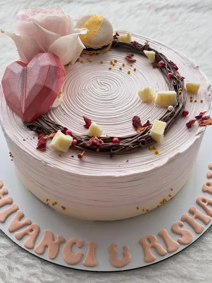 A romantic cake with a geometric chocolate heart, a chocolate nest, and a single pink sugar rose. It's a lovely design for an engagement or anniversary.