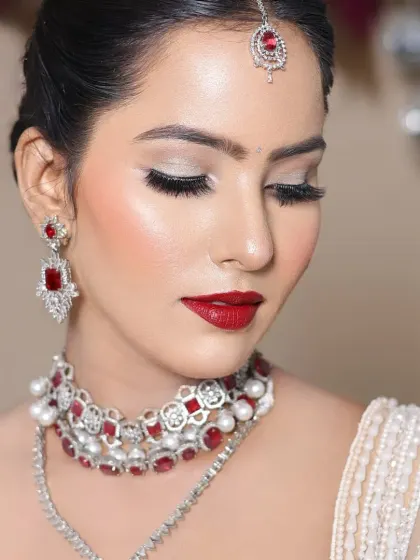 A close-up of the eye makeup, featuring a perfect cut-crease with silver glitter.