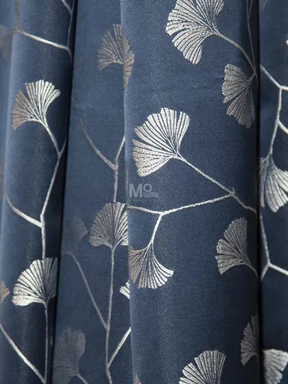 A deep blue curtain fabric featuring elegant ginkgo leaf embroidery in silver. This piece blends luxury, comfort, and style to transform any space.
